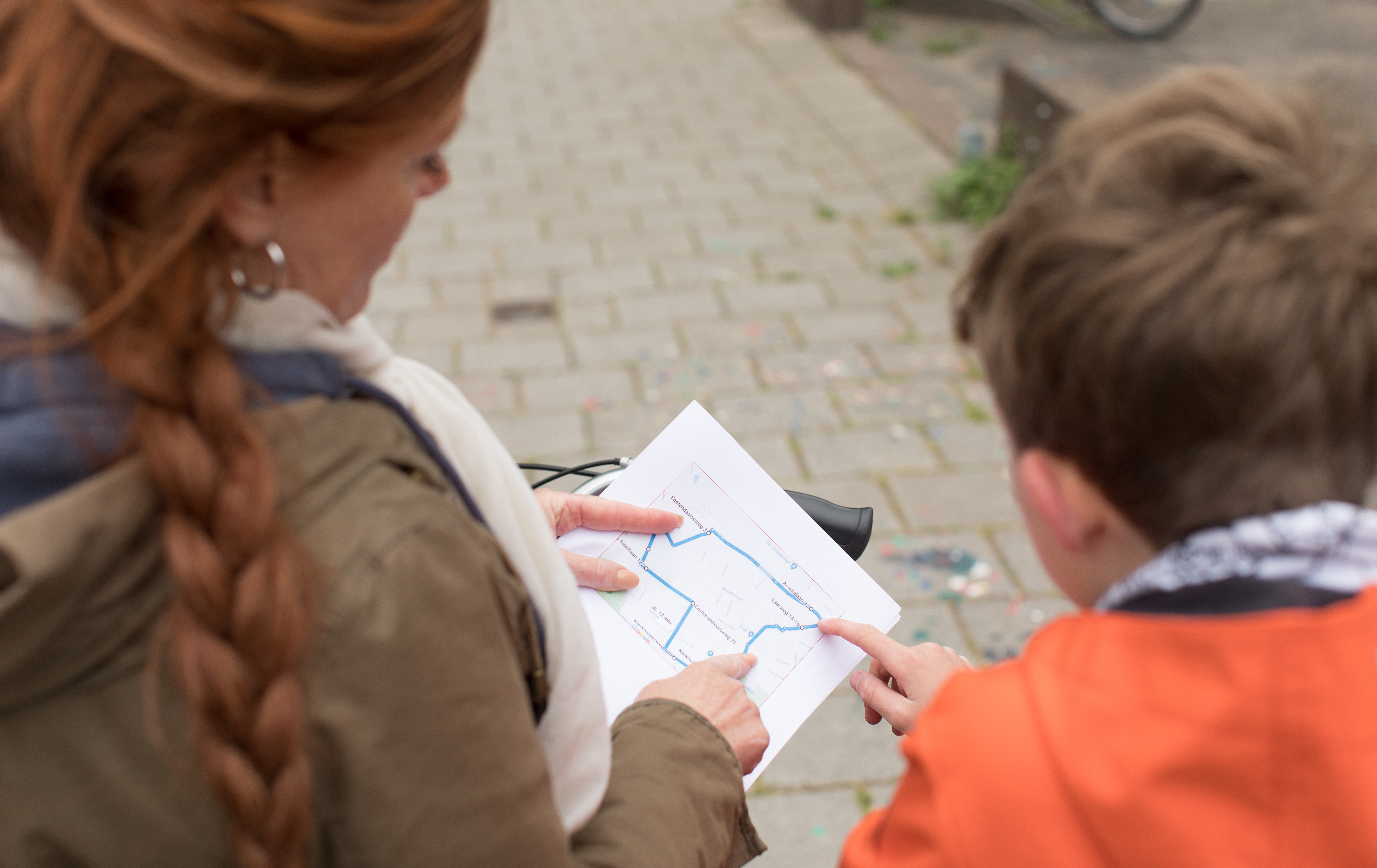 Ouder en kind oefenen voor het praktisch verkeersexamen